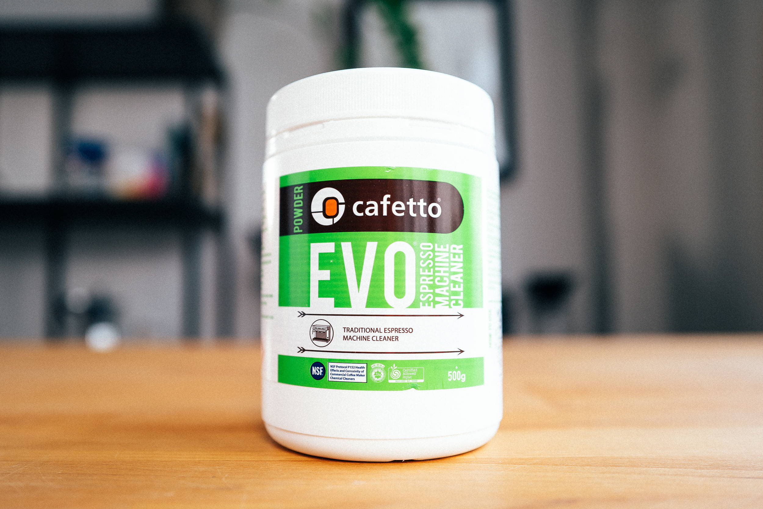 Cafetto EVO Organic Espresso Machine Cleaner stands in a wooden table.