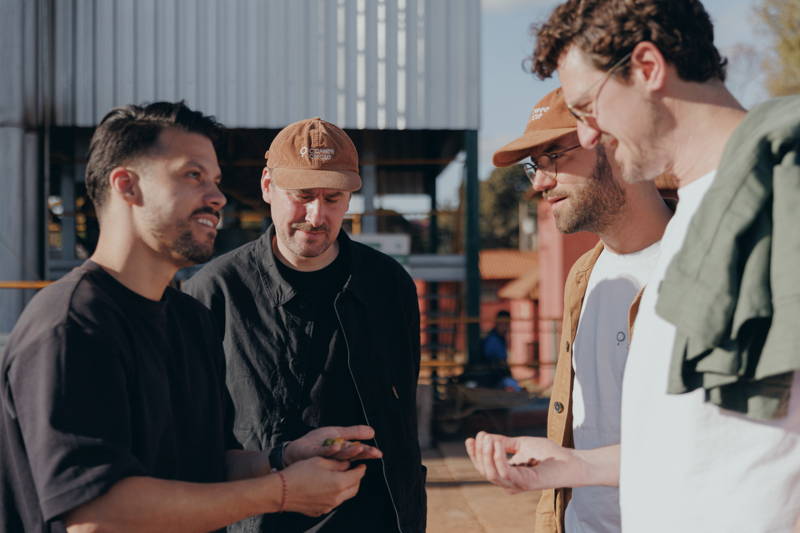 Martin, Hannes, and Robert with a coffee farmer at Daterra 2025