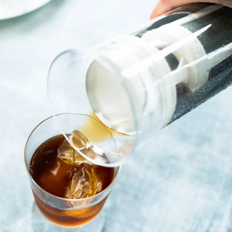 Hario Glass Cold Brew Coffee Pitcher stands on a white table.
