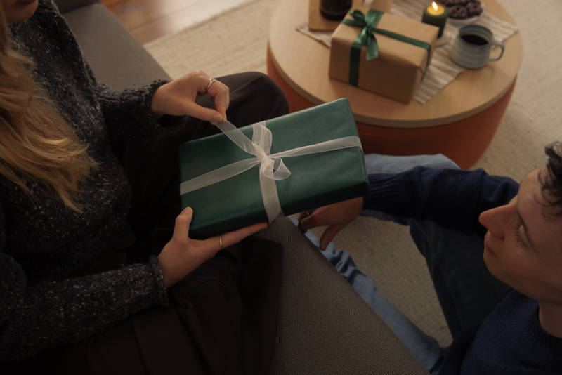 Woman unwrapping presents.