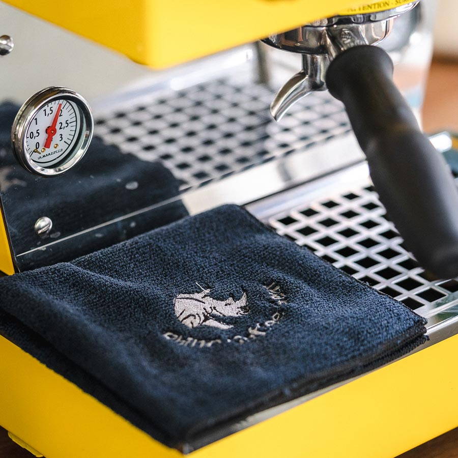 Rhinowares Barista Cloth in blue lying on a espresso machine.