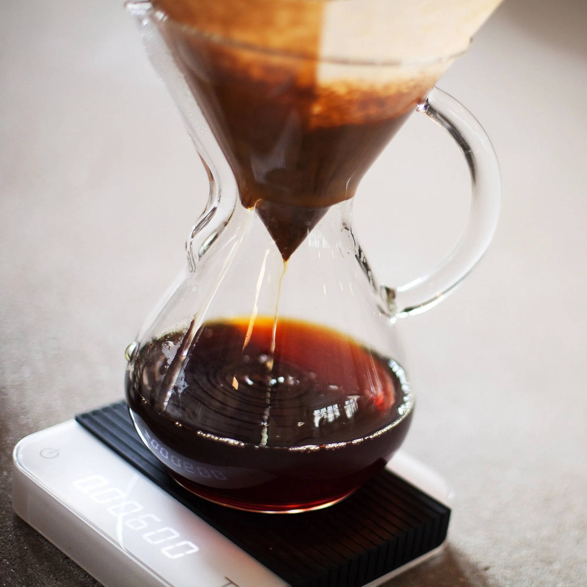 Chemex coffee carafe glass handle for 1-3 cups stands on a scale.