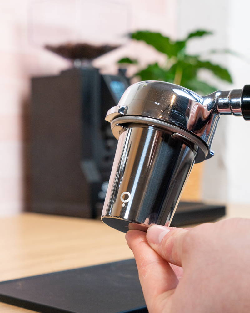 Coffee Circle measuring cup rests on a portafilter.